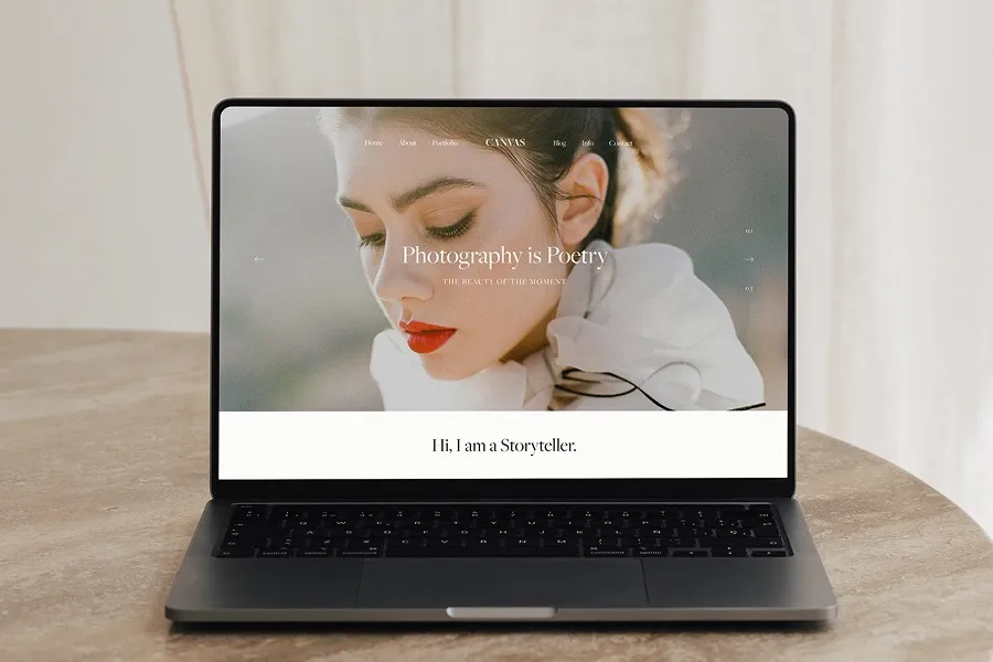 Photographer portfolio website shown on a laptop screen with elegant branding and headline text that reads ‘Photography is Poetry.’