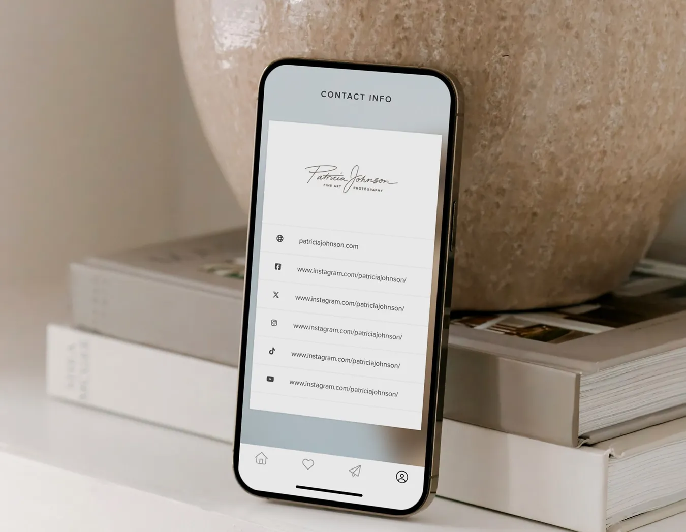 Pixieset Mobile Gallery App is a great way to increase brand awareness. Here, the Mobile Gallery is open & displaying photographer's contact information and social media links on a smartphone.